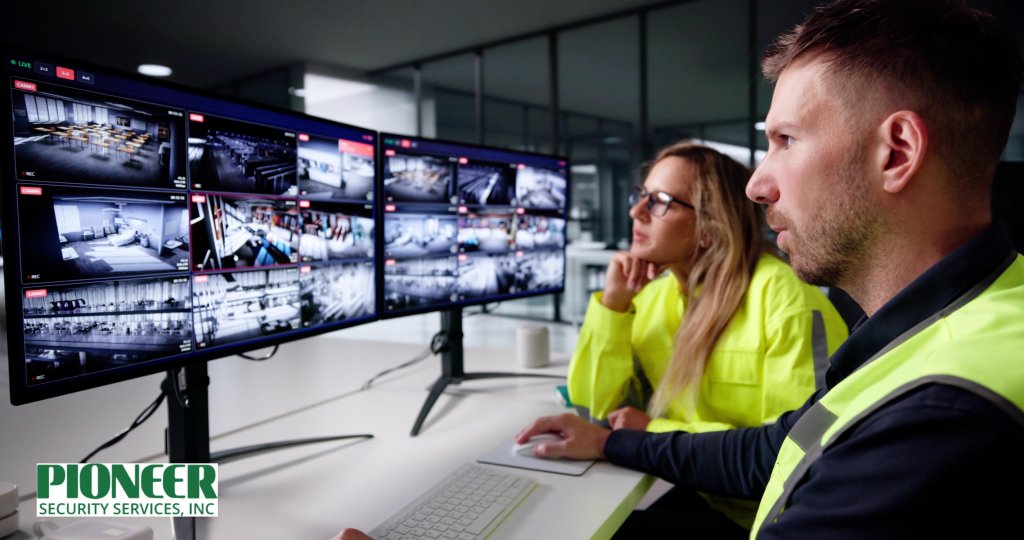 Security operators using control room software to view live feeds from multiple surveillance cameras on dual monitors