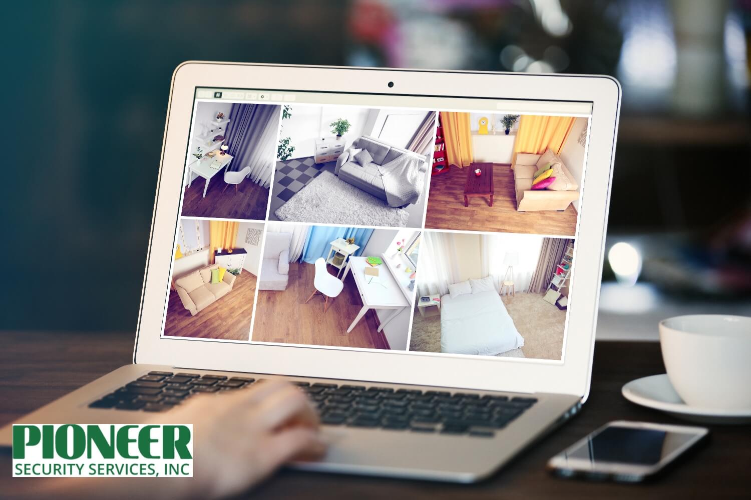 Person checking live home security camera feeds on a laptop for remote monitoring